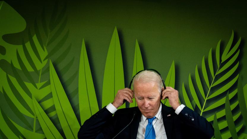 U.S. President Joe Biden puts on headphones to listen to speeches during "Action on Forests and Land-Use" event at the UN Climate Change Conference (COP26) in Glasgow, Scotland, Britain, November 2, 2021. Erin Schaff/Pool via REUTERS