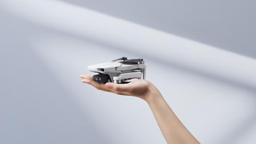 DJI's new Mini SE2 drone sitting on someone's palm. 