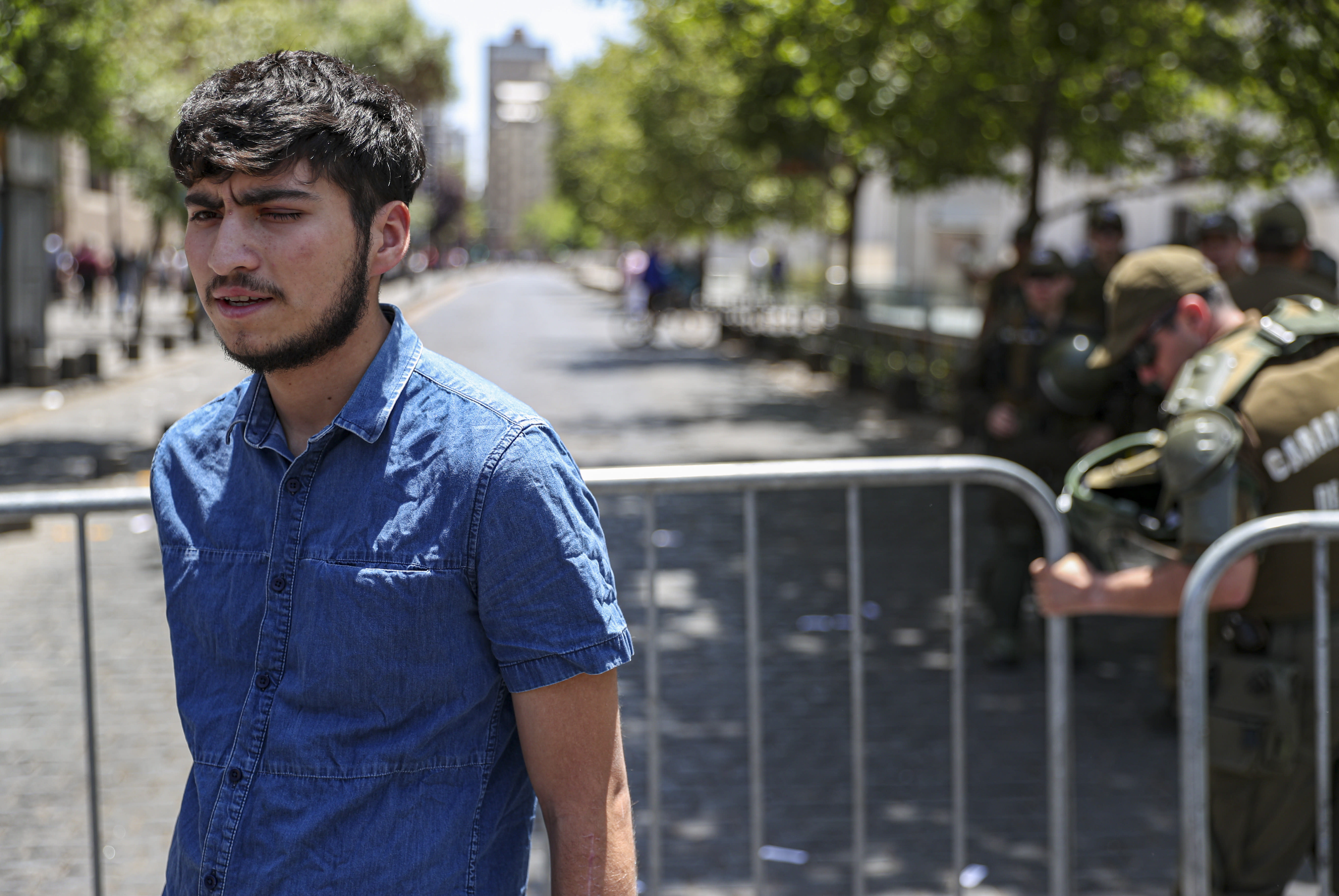 Diego Soppiano, his left injured eye during recent protests, takes part in a demonstration outside the presidential palace, in support of protesters who have been injured in the eye by Chilean police, in Santiago, Chile, Thursday, Nov. 28, 2019. More than 230 anti-government protesters have suffered an eye injury since the social unrest began on Oct. 18. (AP Photo/Esteban Felix)