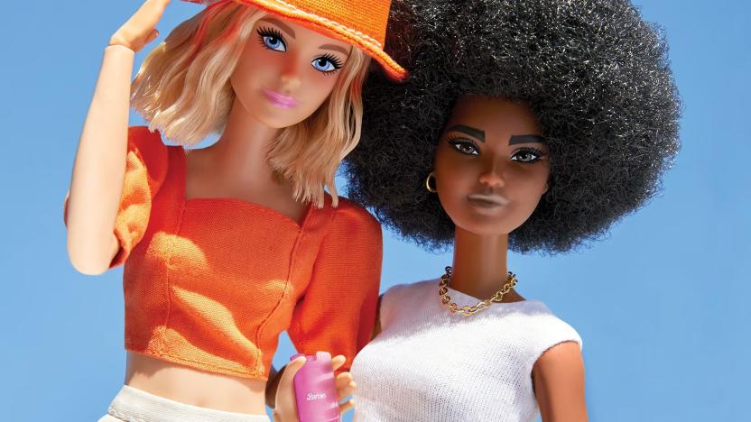 Two Barbies posed next to each other, with one holding a pink Barbie branded filp phone