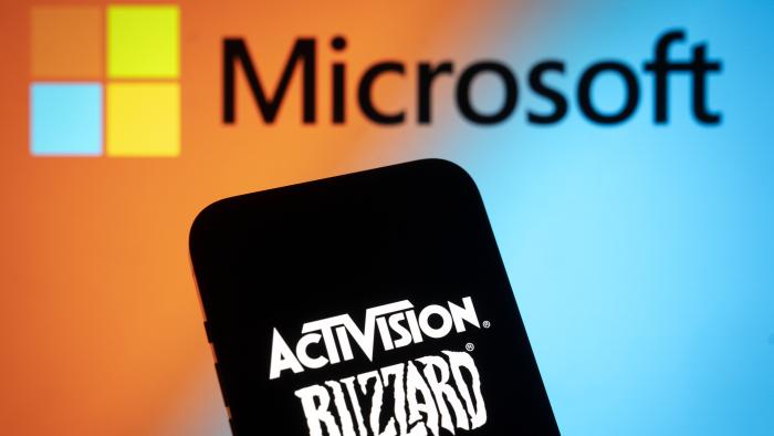 The Activision Blizzard logo is seen with a Microsoft logo in the background in this photo illustration on 13 July, 2023 in Warsaw, Poland. (Photo by Jaap Arriens/NurPhoto via Getty Images)