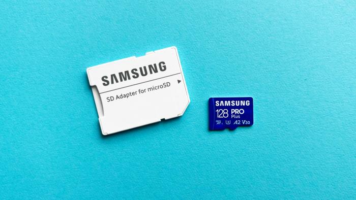 The Samsung Pro Plus microSD card and its accompanying SD adapter sit against a teal background.