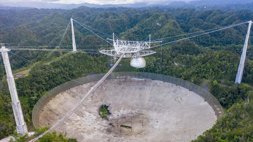 This aerial view shows a hole in the dish panels of the Arecibo Observatory in Arecibo, Puerto Rico, on November 19, 2020. - The National Science Foundation (NSF) announced on November 19, 2020, it will decommission the radio telescope following two cable breaks in recent months which have brought the structure to near collapse. (Photo by Ricardo ARDUENGO / AFP) (Photo by RICARDO ARDUENGO/AFP via Getty Images)