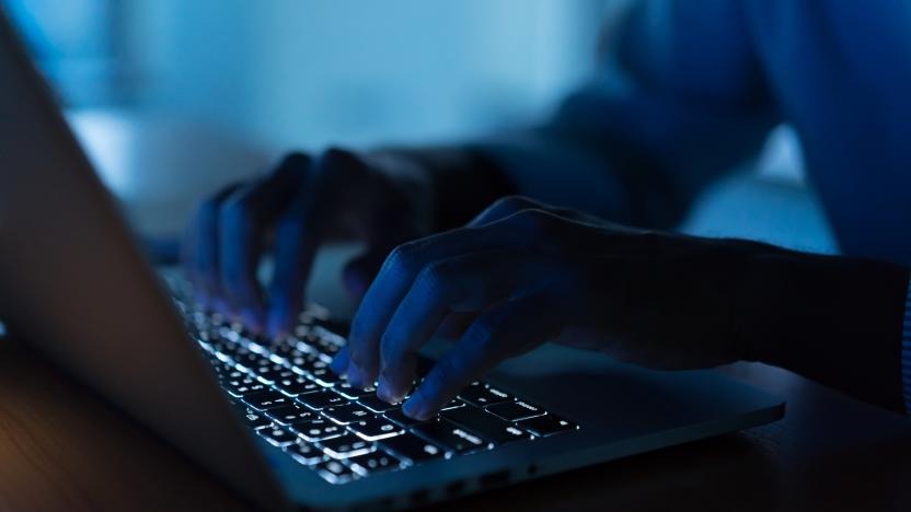 close up programmer man hand typing on keyboard laptop for register data system or access password at dark operation room , cyber security concept