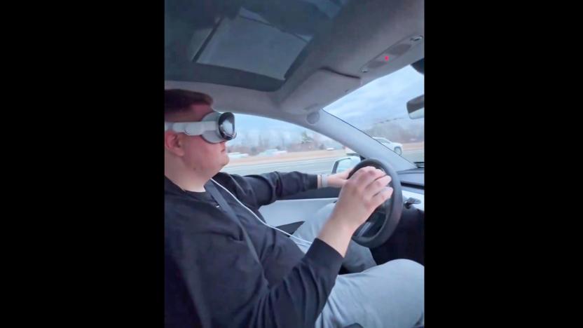 A screenshot from a video posted on X by Dante Lentini of him driving down the highway while wearing an Apple Vision Pro headset.  