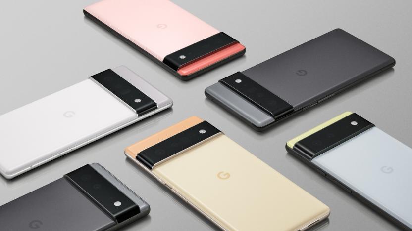 Six Google Pixel 6 and Pixel 6 Pro devices laying on a grey surface at various angles, perpendicular to each other.