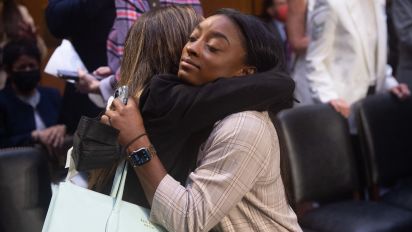 Getty Images - US Olympic gymnast Simone Biles embraces gymnast Kaylee Lorincz after testifying during a Senate Judiciary Committee hearing about the Inspector General's report on the FBI handling of the Larry Nassar investigation of sexual abuse of gymnasts, on Capitol Hill, September 15, 2021, in Washington, DC. (Photo by SAUL LOEB / POOL / AFP) (Photo by SAUL LOEB/POOL/AFP via Getty Images)