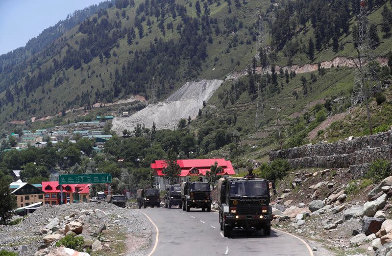 Indian army trucks move along a highway leading to Ladakh, at Gagangeer