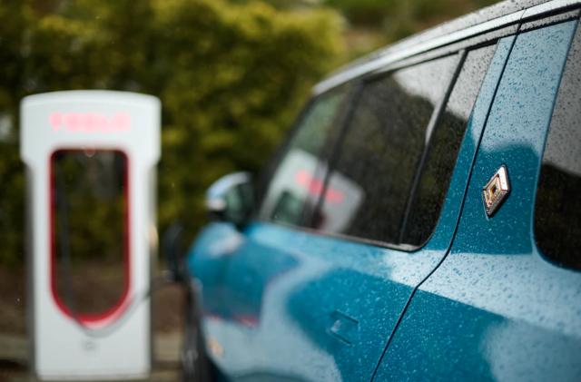 A Rivian EV parked at a charging station. 