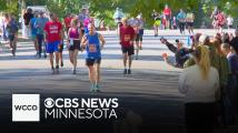 Volunteer runners help to cheer on Twin Cities Marathon participants