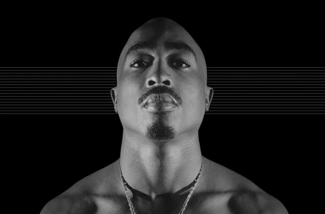 Photo of the late Tupac Shakur, staring down at the camera against a black background with subtle horizontal gray lines.