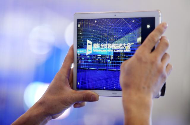 KUNMING, CHINA - MAY 23: A visitor uses Huawei iPad to take photos during the Tencent Global Digital Ecosystem Summit at Dianchi International Convention and Exhibition Center on May 23, 2019 in Kunming, Yunnan Province of China. The Tencent Global Digital Ecosystem Summit is held on May 21-23 in Kunming. (Photo by Visual China Group via Getty Images/Visual China Group via Getty Images)