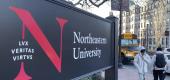 Pedestrians walk near a Northeastern University sign on the school's campus in Boston. (AP)