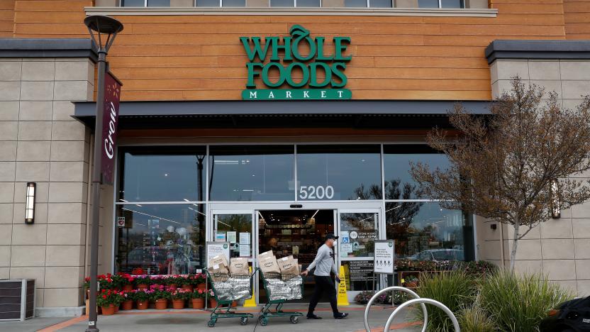 Excelso Sabulau, a 35-year-old independent contract delivery driver for Amazon Flex, pulls a shopping cart full of orders to be delivered near a Whole Foods Market, as the spread of the coronavirus disease (COVID-19) continues, in Dublin, California, U.S., April 6, 2020. Picture taken April 6, 2020. REUTERS/Shannon Stapleton