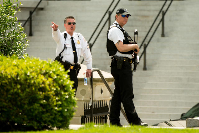 A Secret Service agent orders people into buildings near the entrance to the West Wing of the White House in Washington, May 20, 2016, after the White House was placed on security alert after shooting on street outside. (Andrew Harnik/AP)