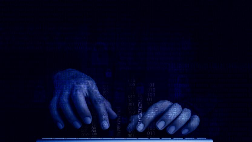 Cyberattack and internet crime, hacking and malware concepts. Digital binary code data numbers and secure lock icons on hacker' hands working with keyboard computer on dark blue tone background.