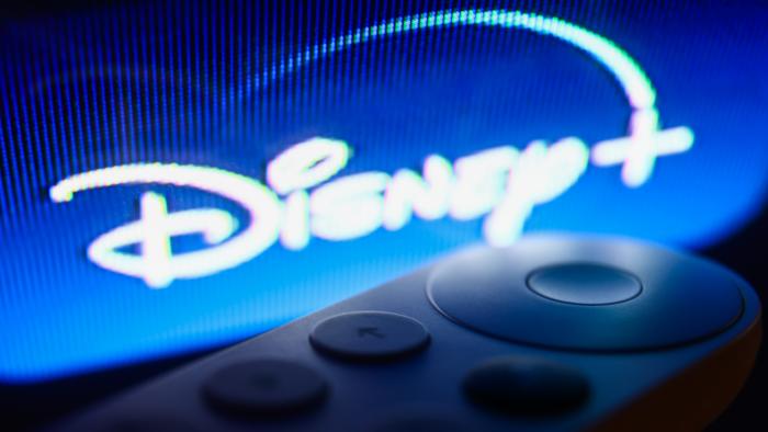Disney+ logo on Chromecast menu displayed on a TV screen and Chromecast remote control are seen in this illustration photo taken in Krakow, Poland on July 19, 2023. (Photo by Jakub Porzycki/NurPhoto via Getty Images)