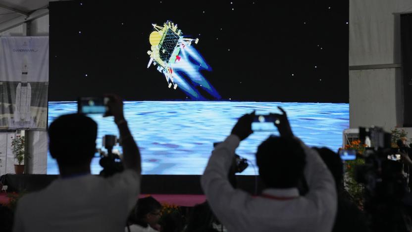 Journalists film the live telecast of spacecraft Chandrayaan-3 landing on the moon at ISRO's Telemetry, Tracking and Command Network facility in Bengaluru, India, Wednesday, Aug. 23, 2023. India lands a spacecraft near the moon’s south pole, becoming the fourth country to touch down on the lunar surface. (AP Photo/Aijaz Rahi)