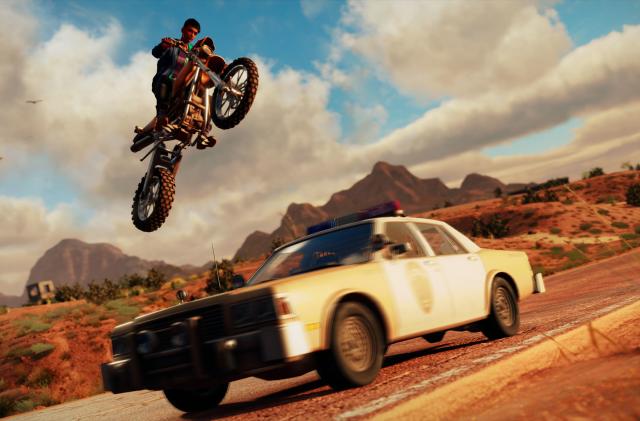 Image of 'The Boss' player protagonist doing a lovely motorcycle jump over an old-timey sherriff's car.