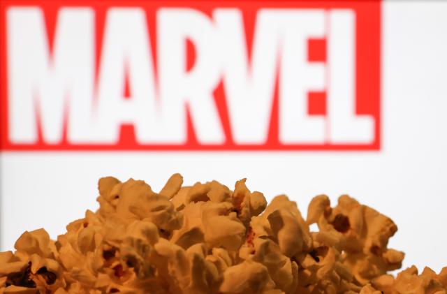 A popcorn and Marvel logo displayed on a screen in the background are seen in this illustration photo taken in Krakow, Poland on August 7, 2023. (Photo by Jakub Porzycki/NurPhoto via Getty Images)