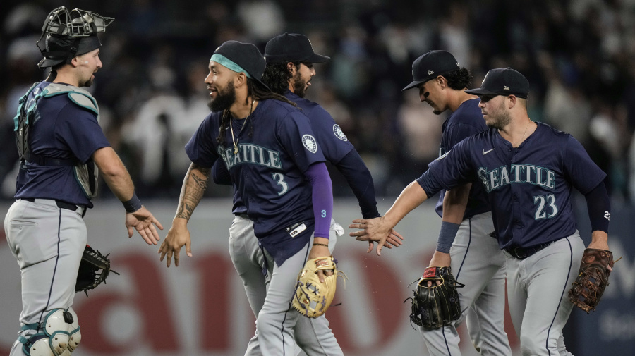 Associated Press - Seattle Mariners' Ty France (23) celebrates with teammates Andrés Muñoz, J.P. Crawford (3) and catcher Cal Raleigh, left, after a baseball game against the New York Yankees, Monday, May 20, 2024, in New York. The Mariners won 5-4. (AP Photo/Frank Franklin II)