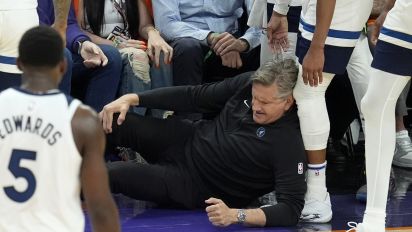 Associated Press - Minnesota Timberwolves head coach Chris Finch holds his knee after colliding with Timberwolves guard Mike Conley during the second half of Game 4 of an NBA basketball first-round playoff series against the Phoenix Suns Sunday, April 28, 2024, in Phoenix. The Timberwolves won 122-116, taking the series 4-0. (AP Photo/Ross D. Franklin)