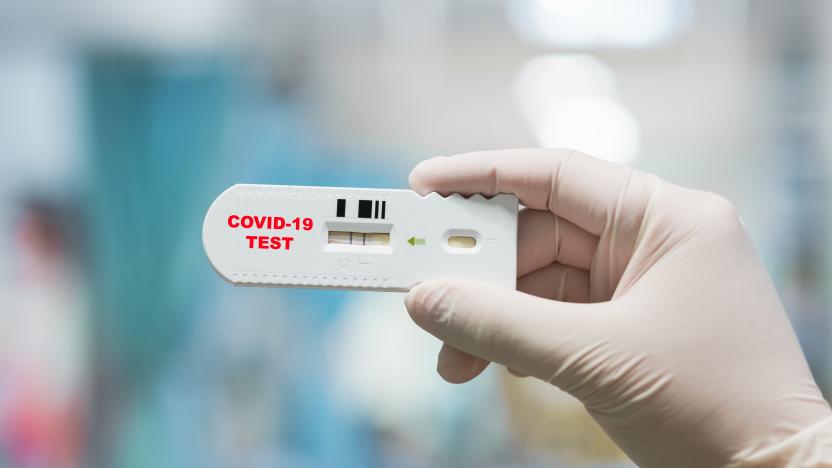 Doctor hand holding positive Coronavirus or Covid-19 rapid test