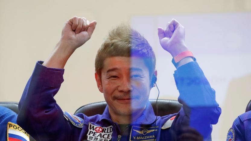 Japanese entrepreneur and space flight participant Yusaku Maezawa gestures behind a glass wall during a news conference in Baikonur, Kazakhstan December 7, 2021. Maezawa, Roscosmos cosmonaut Alexander Misurkin and flight participant Yozo Hirano take part in a mission to the International Space Station (ISS) scheduled for December 8, 2021. REUTERS/Shamil Zhumatov/Pool