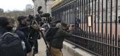 Members of the media take images of an announcement, regarding the death of Britain's Prince Philip, displayed on the fence of Buckingham Palace in London. (AP)