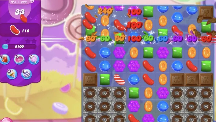 A screenshot of a mobile game showing cartoon candies in a grid.