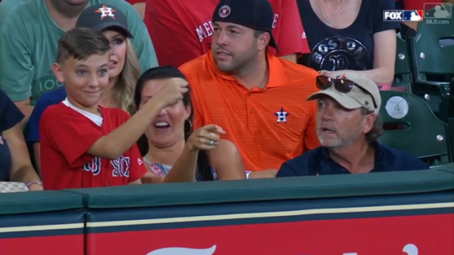 This Red Sox fan was just protecting himself after one fan interfered with a ball. (MLB.com Screenshot)