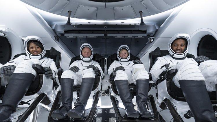 A group photo of the Axiom Mission 2 crew aboard a SpaceX Crew Dragon. From left to right, the astronauts are Rayyanah Barnawi, John Shoffner, Peggy Whitson and Ali Alqarni.