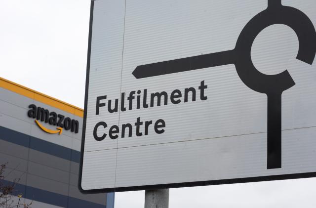 TILBURY, ENGLAND - DECEMBER 16: A road sign shows directions to the Amazon Fulfilment Centre on December 16, 2021 in Tilbury, England. (Photo by John Keeble/Getty Images)