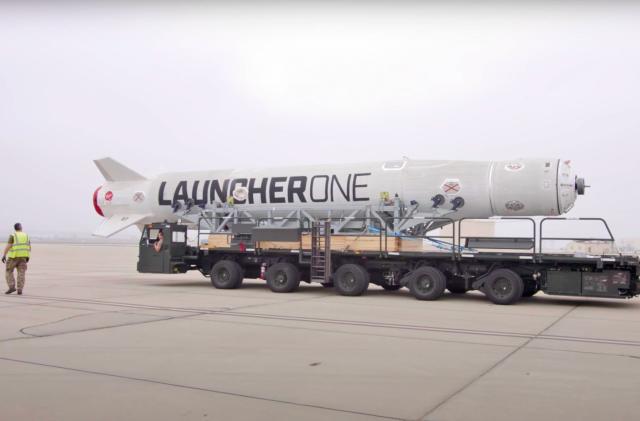 The Launcher One rocket for Virgin Orbit's 'Start Me Up' mission is seen on a runway aboard a wheeled carrier.