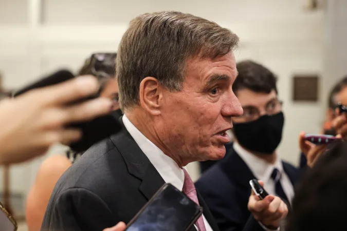 U.S. Senator Mark Warner (D-VA) faces reporters in the Senate subway at the U.S. Capitol in Washington, U.S., October 6, 2021. REUTERS/Evelyn Hockstein 