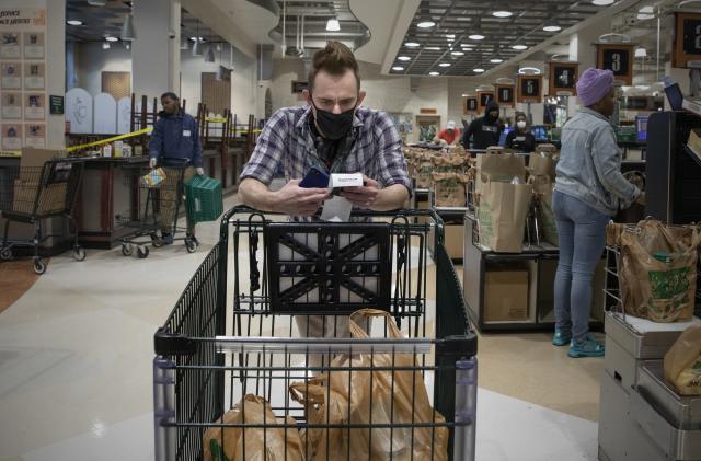 WASHINGTON,DC-APR6: Matt Gillette, a 36 year-old Instacart shopper, checks his order at a Harris Teeter in Washington, DC, April 6, 2020. For the past two years he's been part of the gig economy, driving for Lyft, doing handiwork on TaskRabbit. The work was so unstable he's been on the verge of homelessness, crashing with some friends and asking others to take in his beloved dog, a lab mix named Nitro.

For years there has been talk of a divided America, of an economy that's highly beneficial to some and detrimental to others. The wrath of a highly contagious, sometimes lethal virus has shown us where, precisely, it stands: at the front door. On one side are people who have the luxury of staying safely at home, working -- or not -- and ordering whatever they want to be delivered. On the other side are those doing the delivering. (Photo by Evelyn Hockstein/For The Washington Post via Getty Images)
