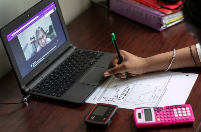 STAMFORD, CONNECTICUT - OCTOBER 28: Abigail Previlon, 13, takes part in remote distance learning with her special education teacher Diane Gamse on October 28, 2020 in Stamford, Connecticut. The eighth grader is hearing impaired and has a translator for in-class learning and often while distance learning on a Chromebook. Students with special needs have additional educational challenges due to the Coronavirus pandemic. A first generation American citizen with Haitian parents, Previlon is fluent in four languages, including English, French, Creole and sign. Stamford Public Schools is currently using a hybrid educational model due to the Coronavirus pandemic, with a combination of in-class and distance learning. (Photo by John Moore/Getty Images)