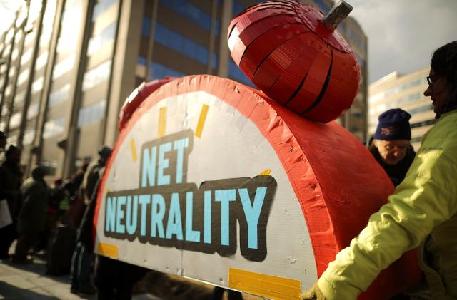 WASHINGTON, DC - DECEMBER 14:  Rally organizers carry away props following a protest outside the Federal Communication Commission building against the end of net neutralityrules December 14, 2017 in Washington, DC. Lead by FCC Chairman Ajit Pai, the commission is expected to do away with Obama Administration rules that prevented internet service providers from creating different levels of service and blocking or promoting individual companies and organizations on their systems.  (Photo by Chip Somodevilla/Getty Images)