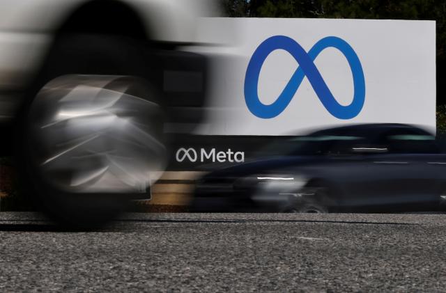 Cars drive past a sign of Meta, the new name for the company formerly known as Facebook, at its headquarters in Menlo Park, California, U.S. October 28, 2021. REUTERS/Carlos Barria     TPX IMAGES OF THE DAY