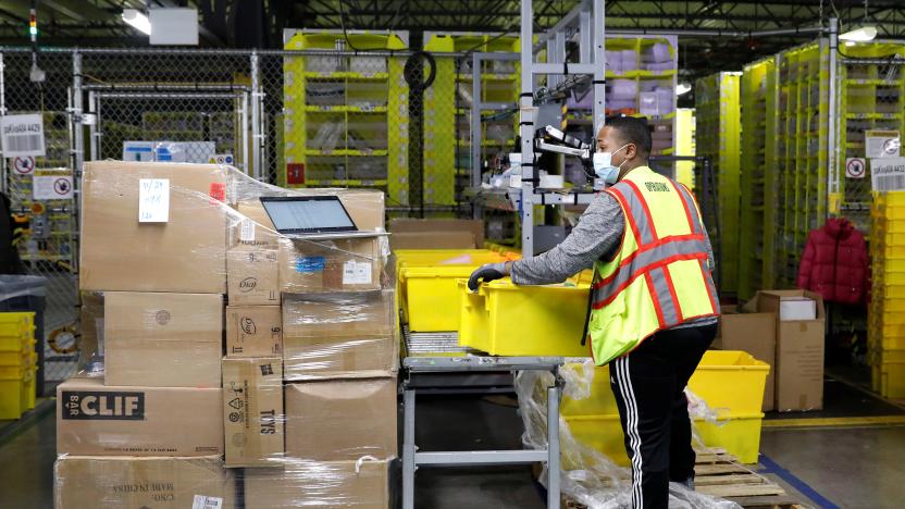 An employee fills a cart full of items at Amazon's JFK8 distribution center in Staten Island, New York, U.S. November 25, 2020.  REUTERS/Brendan McDermid.