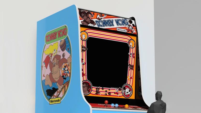 A large Donkey Kong arcade cabinet is shown with a black human figure standing at a smaller control panel in front of it.