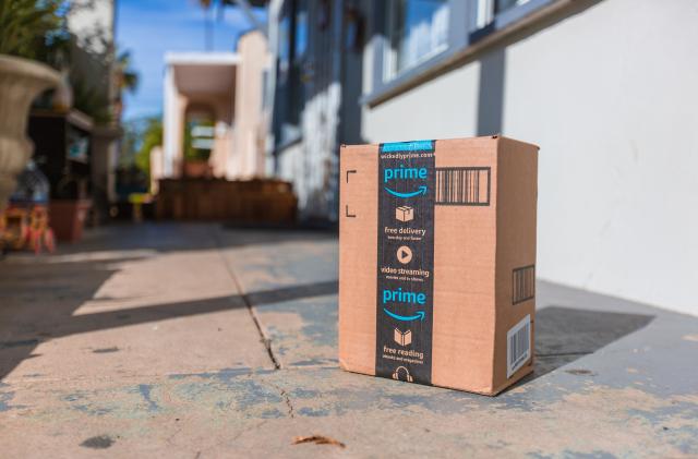 Los Angeles CA, November 11/22/2017: Image of an Amazon packages. Amazon is an online company and is the largest retailer in the world. Cardboard package delivery at front door during the holiday season. shipping package parcel box on wooden floor with protection paper inside. Amazon.com went online in 1995 and is now the largest online retailer in the world.