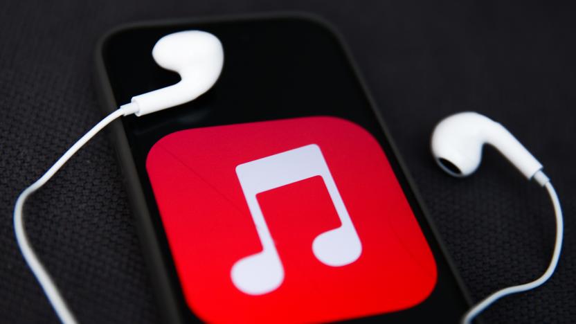 Headphones and Apple Music logo displayed on a phone screen are seen in this illustration photo taken in Krakow, Poland on December 5, 2023. (Photo by Jakub Porzycki/NurPhoto via Getty Images)