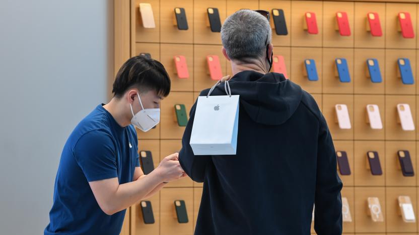 SYDNEY, AUSTRALIA - SEPTEMBER 24: A man holds his bag containing his new iPhone as he talks to an Apple Store staff member on September 24, 2021 in Sydney, Australia. The new Apple iPhone 13 and iPhone 13 Pro went on sale at Apple Sydney in Australia today. iPhone 13 Pro offers customers the most advanced camera system ever on iPhone, a Super Retina XDR display with ProMotion and is powered by A15 Bionic, the fastest chip in a smartphone. Additionally the iPad mini and a new iPad also went on sale today. Due to current COVID-19 lockdown restrictions in Sydney, customers are able to pick up their pre-ordered products with click and collect, but are not able to shop in-store. (Photo by James D. Morgan/Getty Images)