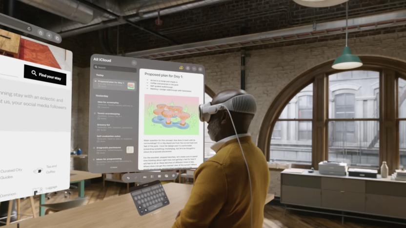 A man wears a Vision Pro headset and looks at various apps overlaid over a room