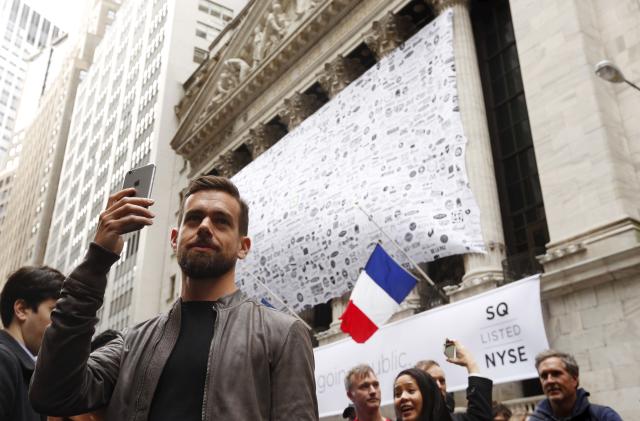 Jack Dorsey, CEO of Square and CEO of Twitter, uses his phone to live cast during an event outside of the New York Stock Exchange to celebrate the IPO of Square Inc., in New York November 19, 2015. Square Inc priced shares at $9 for its initial public offering, about 25 percent less than it had hoped, as it struggled to win over investors skeptical about its business and valuation before trading begins on Thursday.  REUTERS/Lucas Jackson