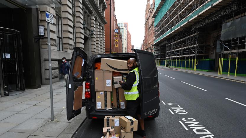 A delivery driver unloads Amazon-branded boxes in Manchester, northwest England as the country battles a surge in coronavirus cases on October 19, 2020 (Photo by Paul ELLIS / AFP) (Photo by PAUL ELLIS/AFP via Getty Images)