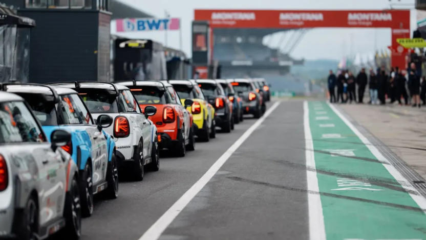 Mini Cooper SE-based LRT NXT1 electric racecars line up on the grid.