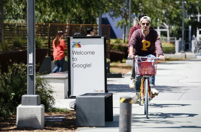 MOUNTAIN VIEW, CA - MAY 01: People ride bikes past signage on the Google campus as Google workers inside hold a sit-in to protest sexual harassment at the company, on May 1, 2019 in Mountain View, California. (Photo by Michael Short/Getty Images)