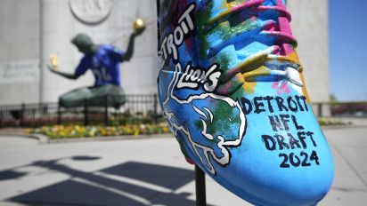 Associated Press - An NFL football draft cleat is displayed near the Spirit of Detroit statue, Friday, April 19, 2024, in Detroit. The draft has taken the show on the road for a decade, giving cities a chance around the country a chance to be in the spotlight. (AP Photo/Carlos Osorio)